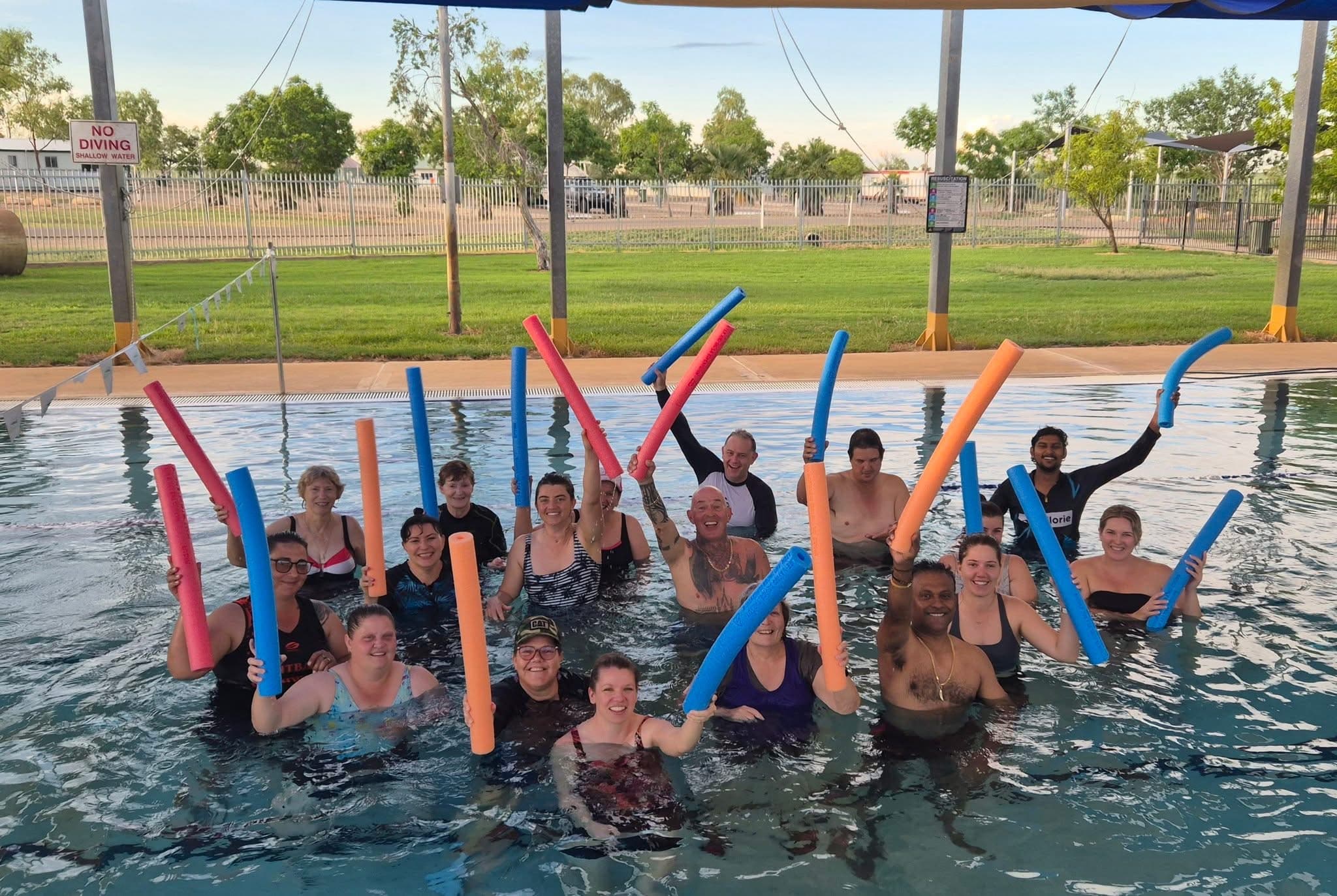 PDM’s McKinlay Shire Council team in the pool with foam noodles at an aqua aerobics session