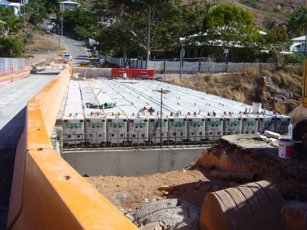 Precast deck units laid across the new Victoria Street Bridge, with traffic barriers along the adjoining road