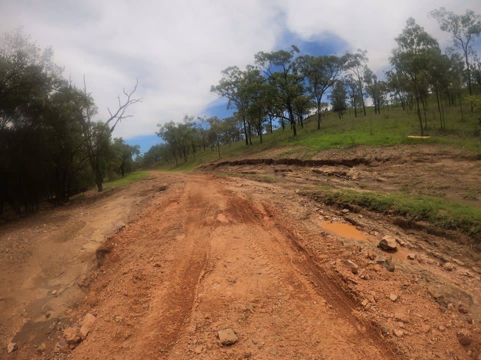 Flood damage on Burdekin Road: a rutted, scoured gravel surface