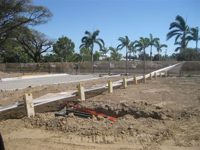 New kerb and set-out pegs along a subdivision street under construction at Oonoonba